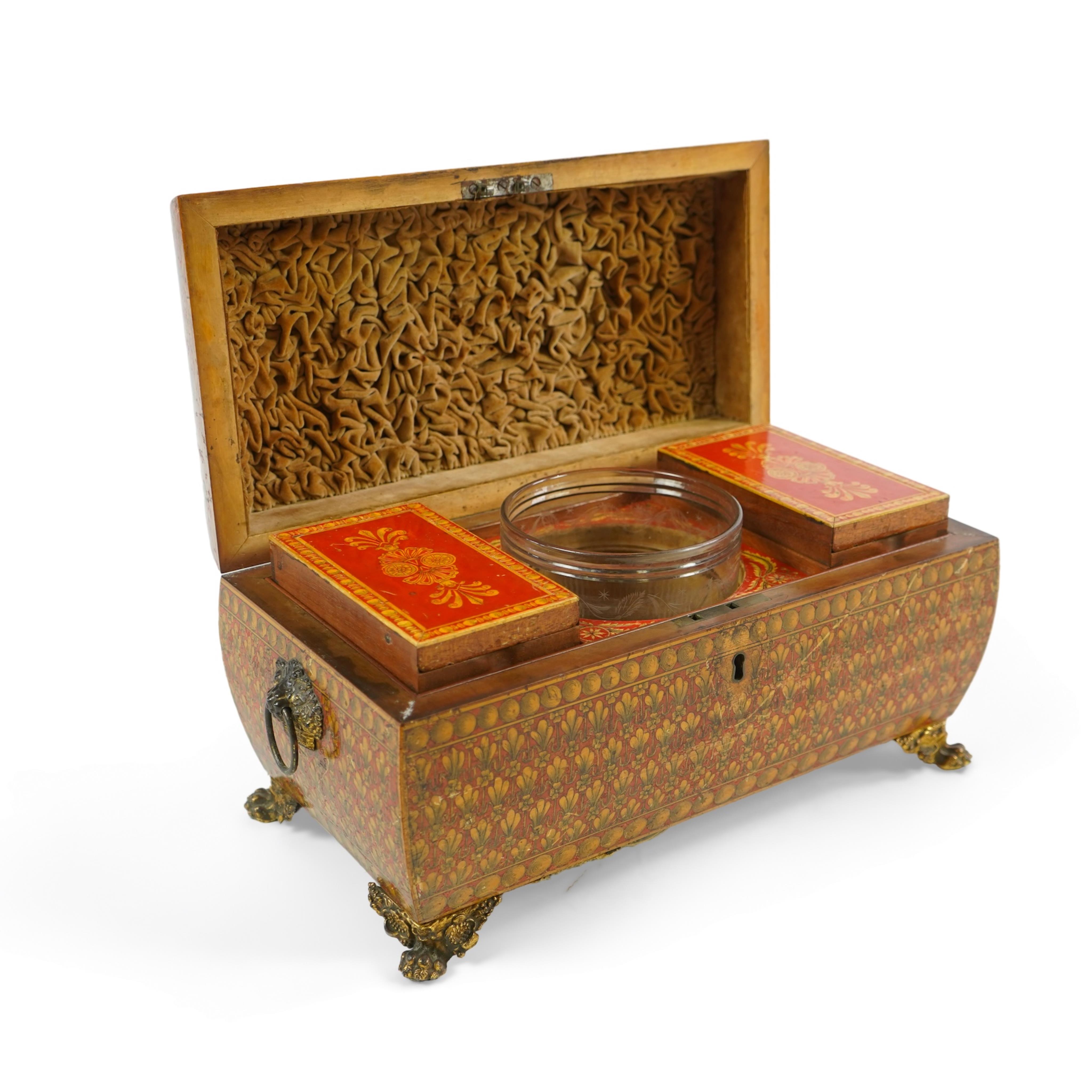 A Regency red lacquer penwork tea caddy